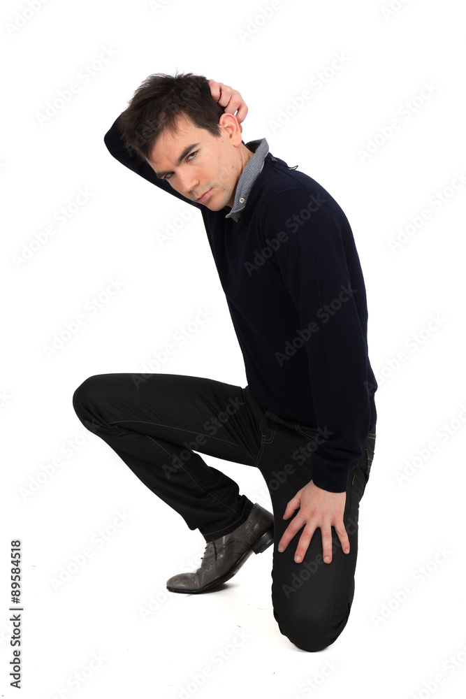 Handsome man doing different expressions in different sets of clothes: kneeling