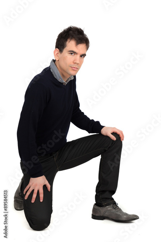 Handsome man doing different expressions in different sets of clothes: kneeling