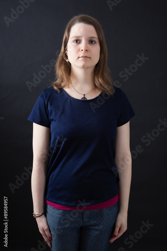 Beautiful woman doing different expressions in different sets of clothes: at attention