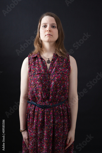 Beautiful woman doing different expressions in different sets of clothes: at attention
