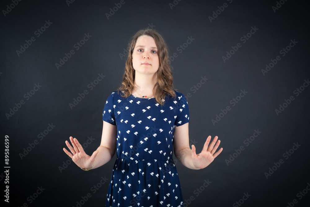 Beautiful woman doing different expressions in different sets of clothes: stop sign Beautiful woman doing different expressions in different sets of clothes: stop sign