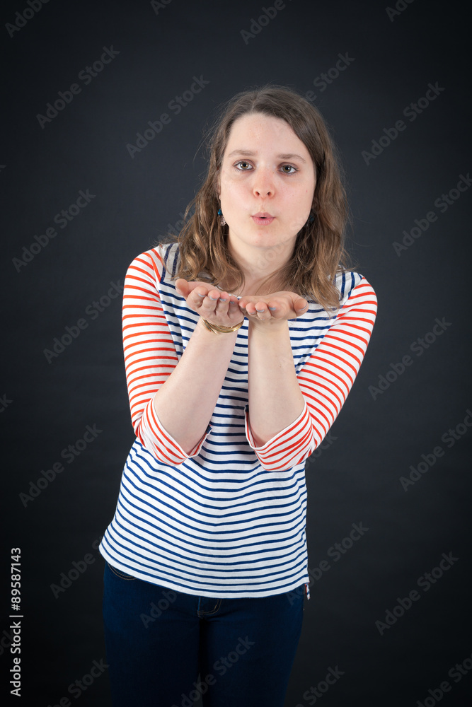 Beautiful woman doing different expressions in different sets of clothes: kiss Beautiful woman doing different expressions in different sets of clothes: kiss