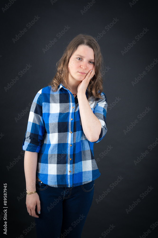 Beautiful woman doing different expressions in different sets of clothes: toothache Beautiful woman doing different expressions in different sets of clothes: toothache