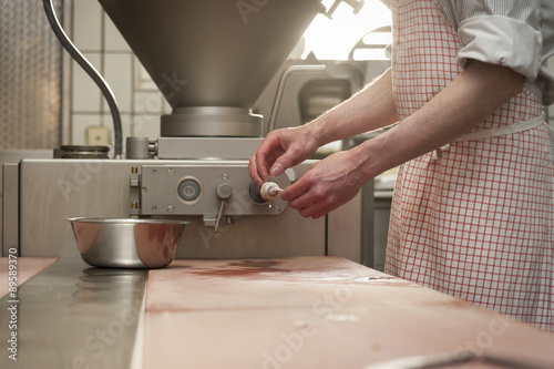Preparation of smoked sausage, Butcher filling sausage casing photo