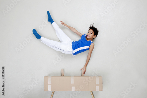 Boy exercising on vaulting horse