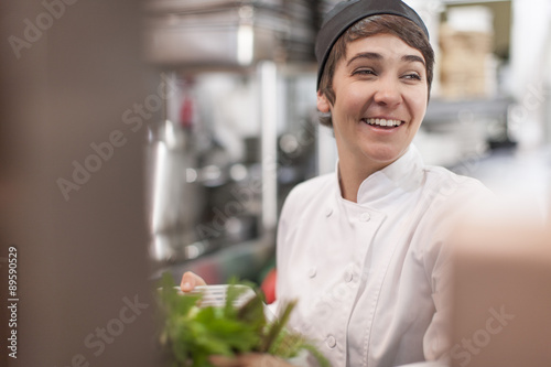 Young chef in commercial kitchen photo