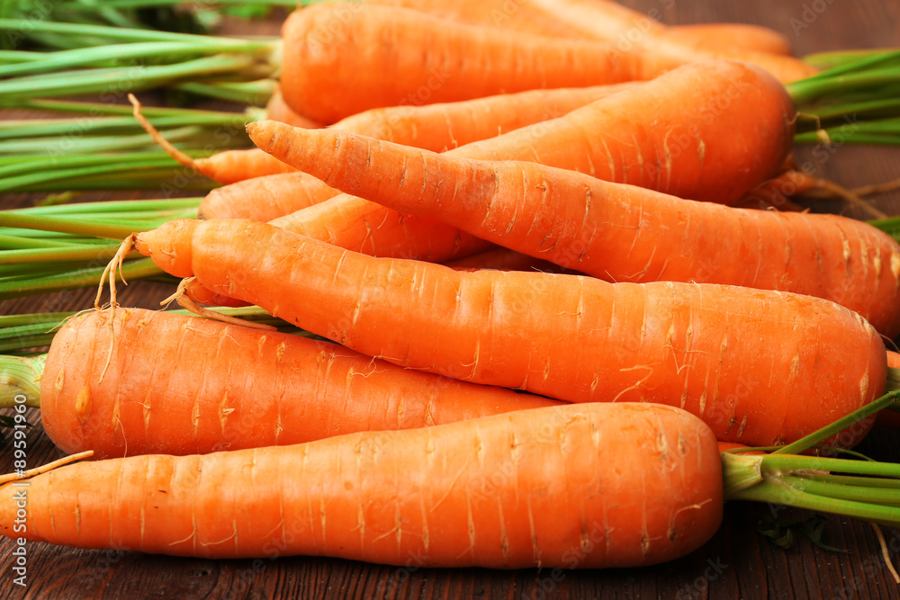 Fresh organic carrots on wooden table, closeup Fresh organic carrots on wooden table, closeup