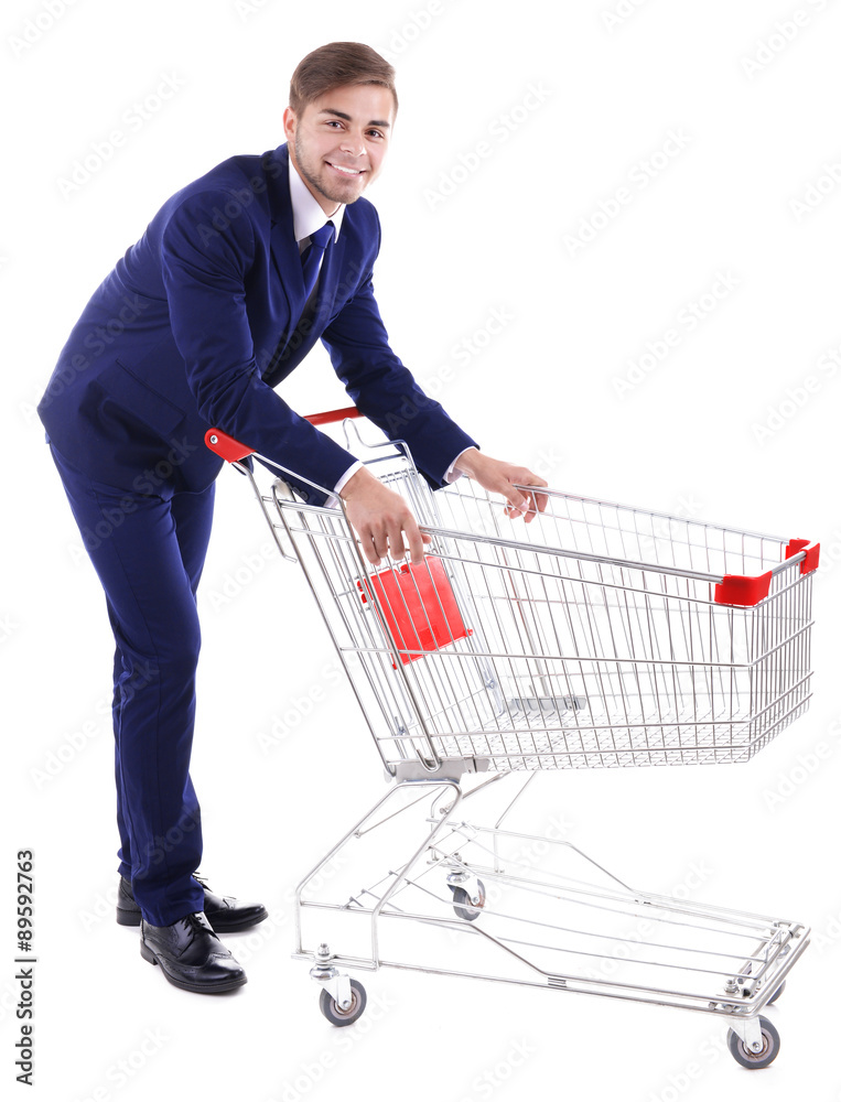 Young man with empty shopping cart, isolated on white Young man with empty shopping cart, isolated on white