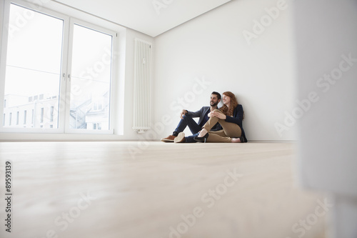 Wallpaper Mural Young couple sitting on floor of their new flat Torontodigital.ca