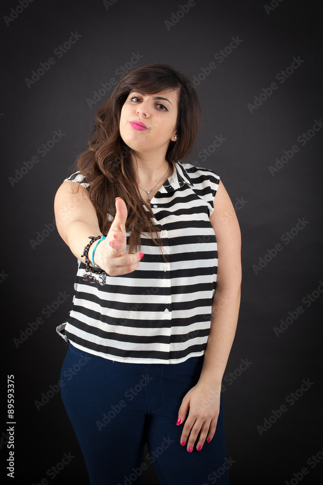 Beautiful woman doing different expressions in different sets of clothes: gun sign Beautiful woman doing different expressions in different sets of clothes: gun sign