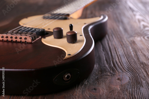 Electric guitar on wooden table close up