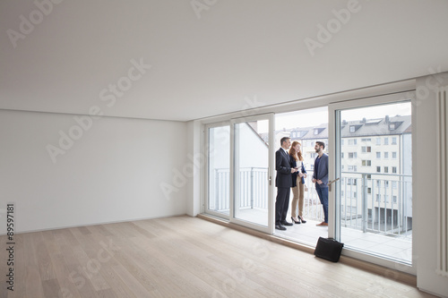 Young couple viewing flat with estate agent