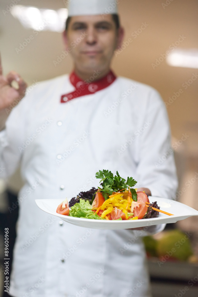 chef in hotel kitchen preparing and decorating food chef in hotel kitchen preparing and decorating food