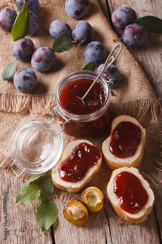 Fototapeta Naklejka Na Ścianę i Meble -  Freshly brewed plum jam and toast close-up. vertical top view

