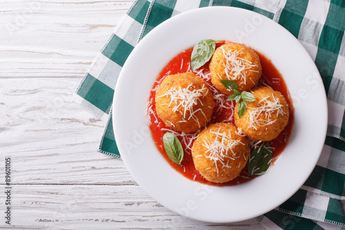 fried arancini rice balls with tomato sauce. horizontal top view
