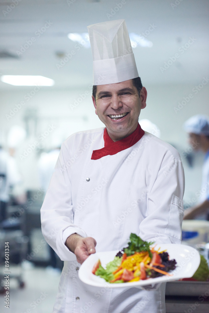 chef in hotel kitchen preparing and decorating food chef in hotel kitchen preparing and decorating food