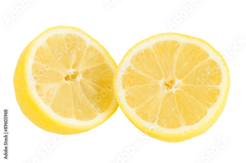 Close-up of a ripe lemon cut in half, isolated on white background.