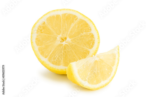 Close-up of half and quarter slices of lemon, isolated on white background.