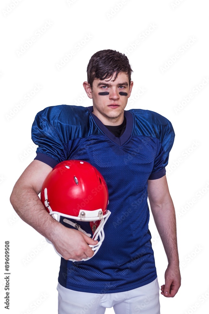 American football player holding an helmet American football player holding an helmet
