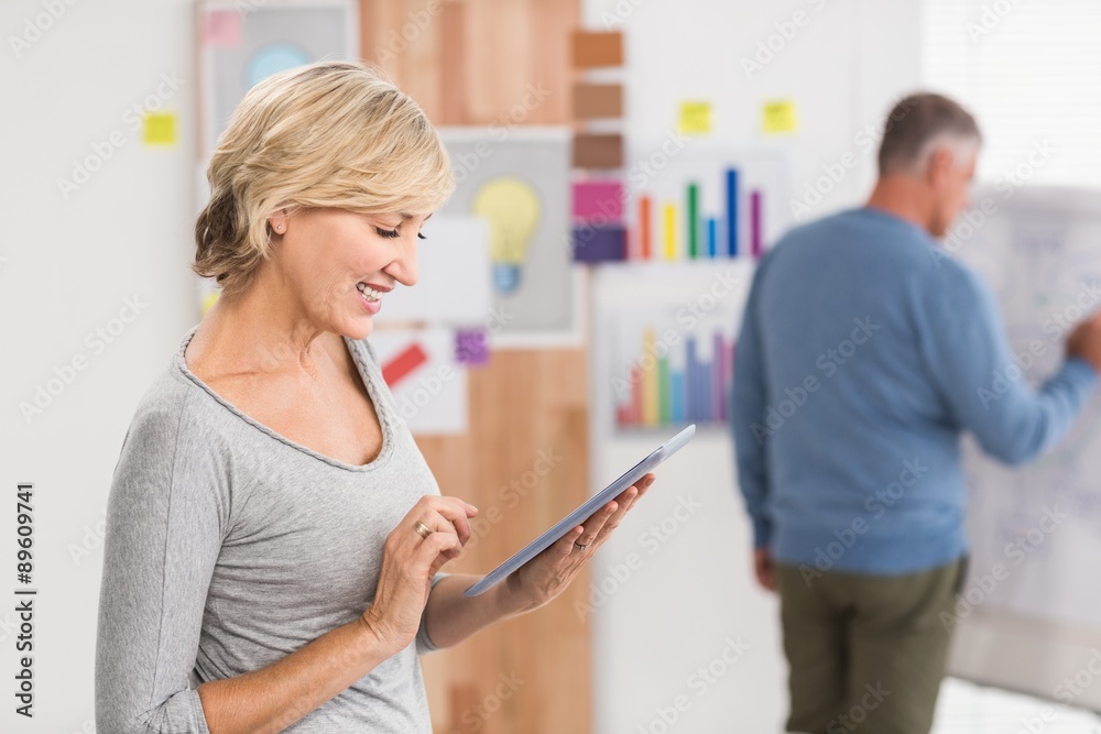 Smiling businesswoman using a digital tablet Smiling businesswoman using a digital tablet