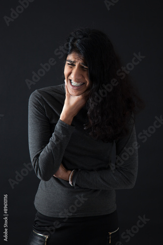 Beautiful woman doing different expressions in different sets of clothes: toothache