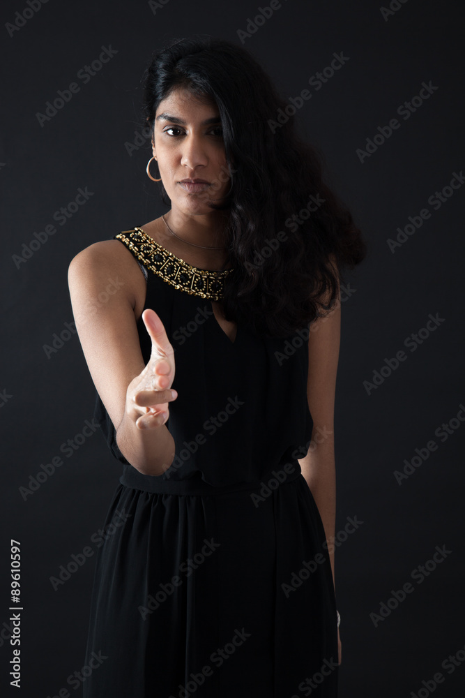 Beautiful woman doing different expressions in different sets of clothes: gun sign