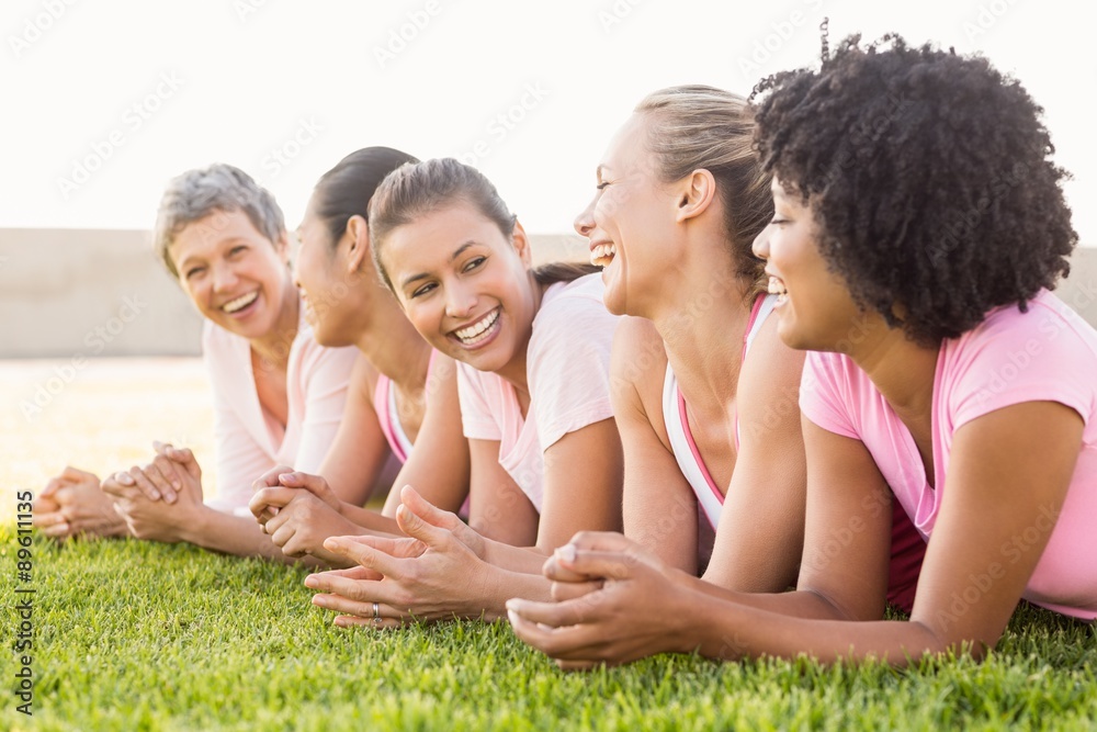 Smiling women lying in a row and wearing pink for breast cancer Smiling women lying in a row and wearing pink for breast cancer