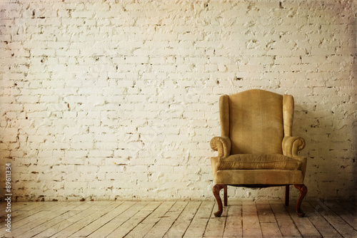Old Retro Armchair against White Brick Wall Interior
