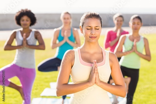 Peaceful sporty brunette doing yoga in yoga class