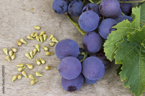 Grapes and grape seed on a wooden table