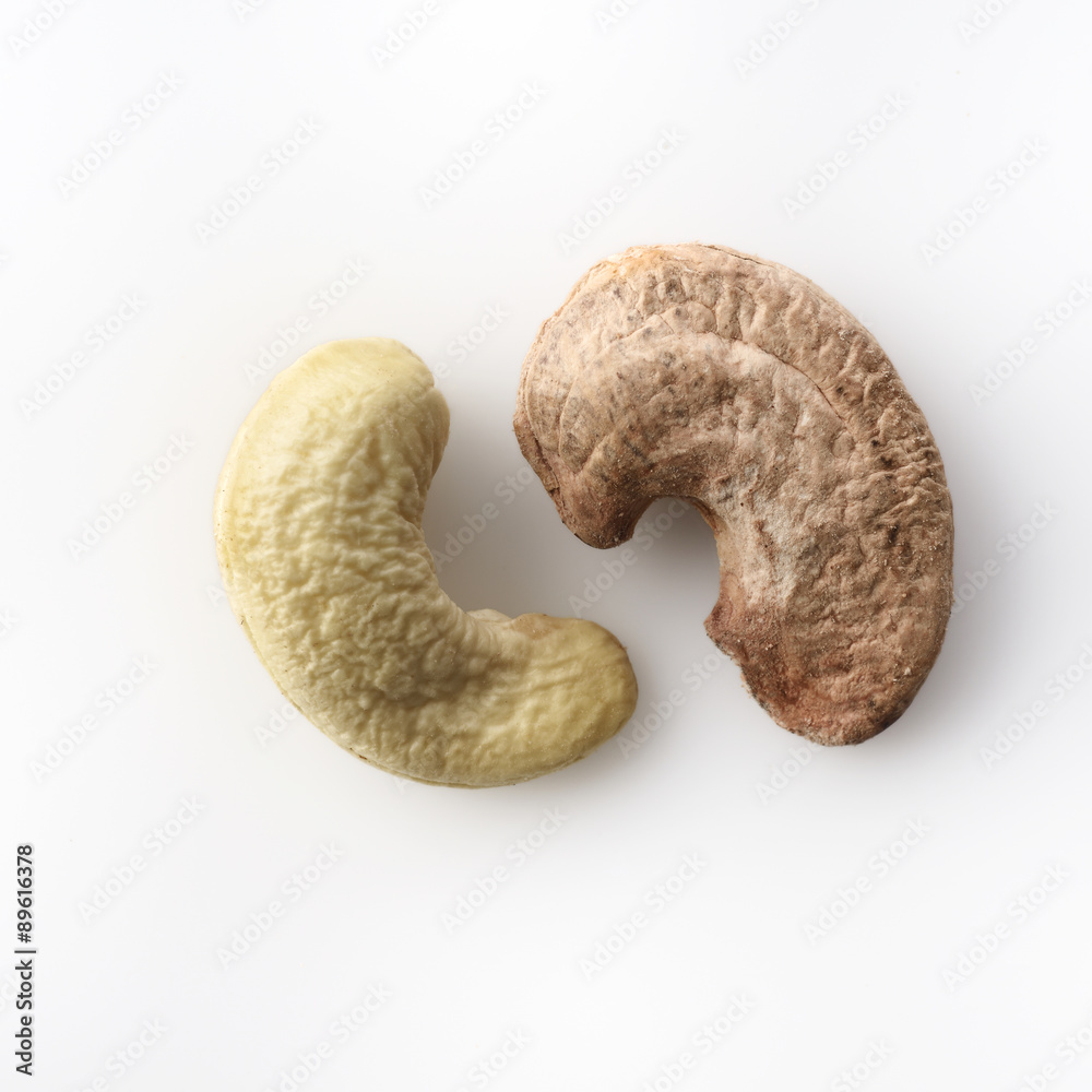 Cashews with and without skin on white background shot in studio. Cashews with and without skin on white background shot in studio.