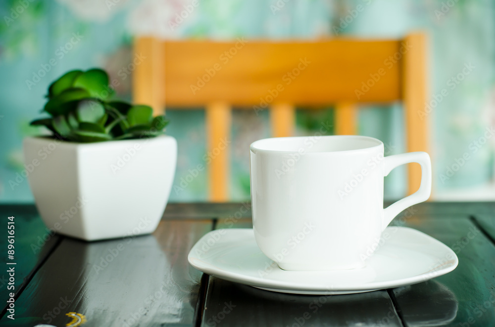 Obraz premium Cup of hot coffee on the table in the cafe