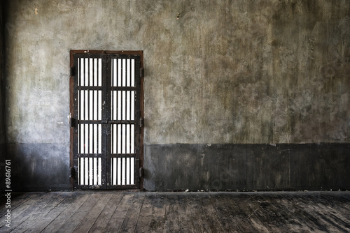 Fotografie Rusted iron bars door on old wall