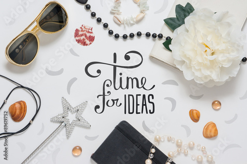 Photo of workplace with lots of different objects and glasses.