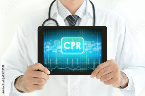 Doctor holding tablet pc with CPR sign on screen