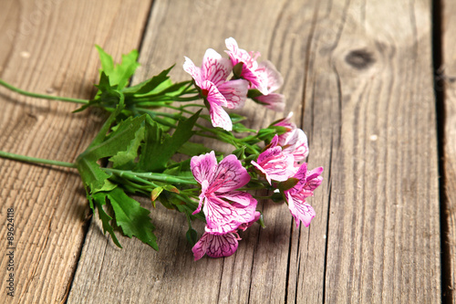 beautiful flowers lie on old wooden table