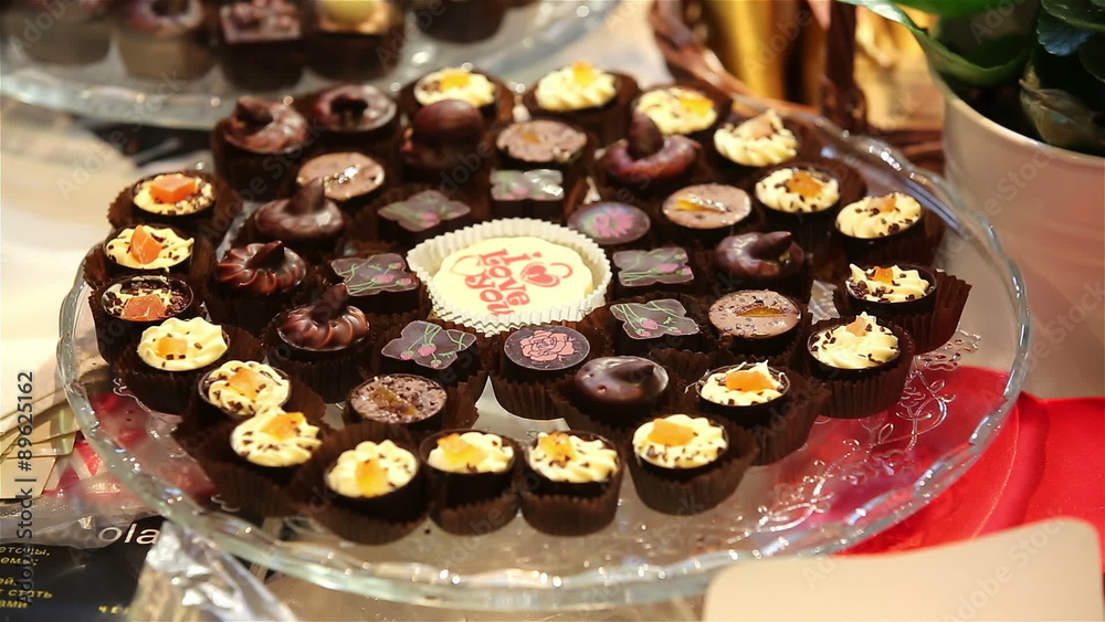 Lots of chocolates on display. The seller lays out candy on display. Lots of chocolates on display. The seller lays out candy on display.