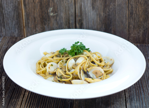 Spaghetti alla vongole on a wooden background