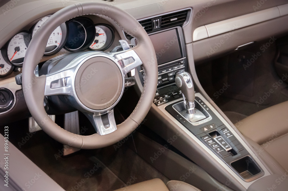 Dark luxury car Interior - steering wheel, shift lever and dashb