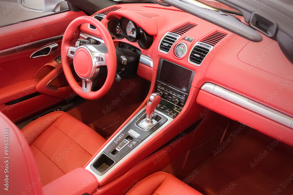 Red luxury car Interior - steering wheel, shift lever and dashbo