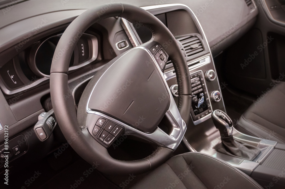 Black luxury car Interior - steering wheel, shift lever and dash