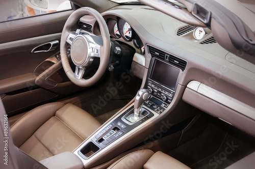 Dark luxury car Interior - steering wheel, shift lever and dashb © vchalup