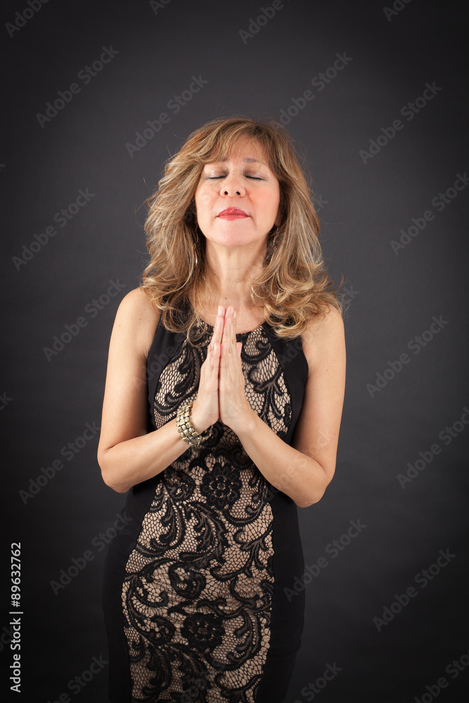 Beautiful woman doing different expressions in different sets of clothes: prayer Beautiful woman doing different expressions in different sets of clothes: prayer