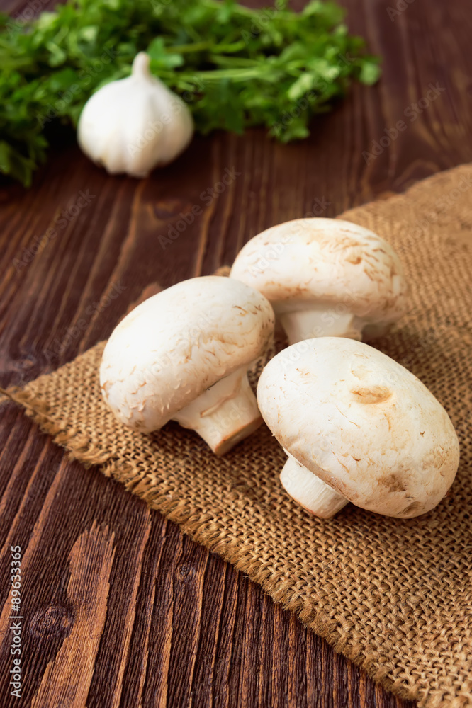 Organic vegetables on wooden background. Onion, parsley, champig