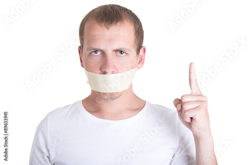 censorship concept - portrait of young man with tape on mouth photo