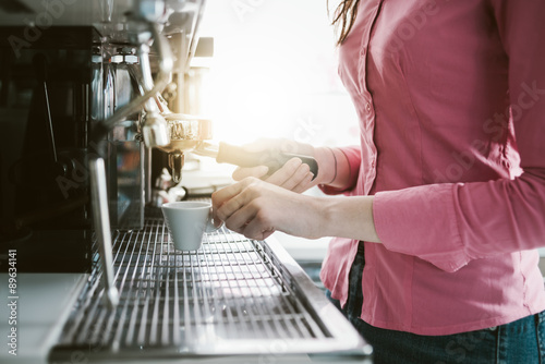 Waitress making coffee