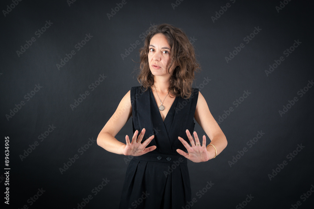 Beautiful woman doing different expressions in different sets of clothes: stop sign Beautiful woman doing different expressions in different sets of clothes: stop sign