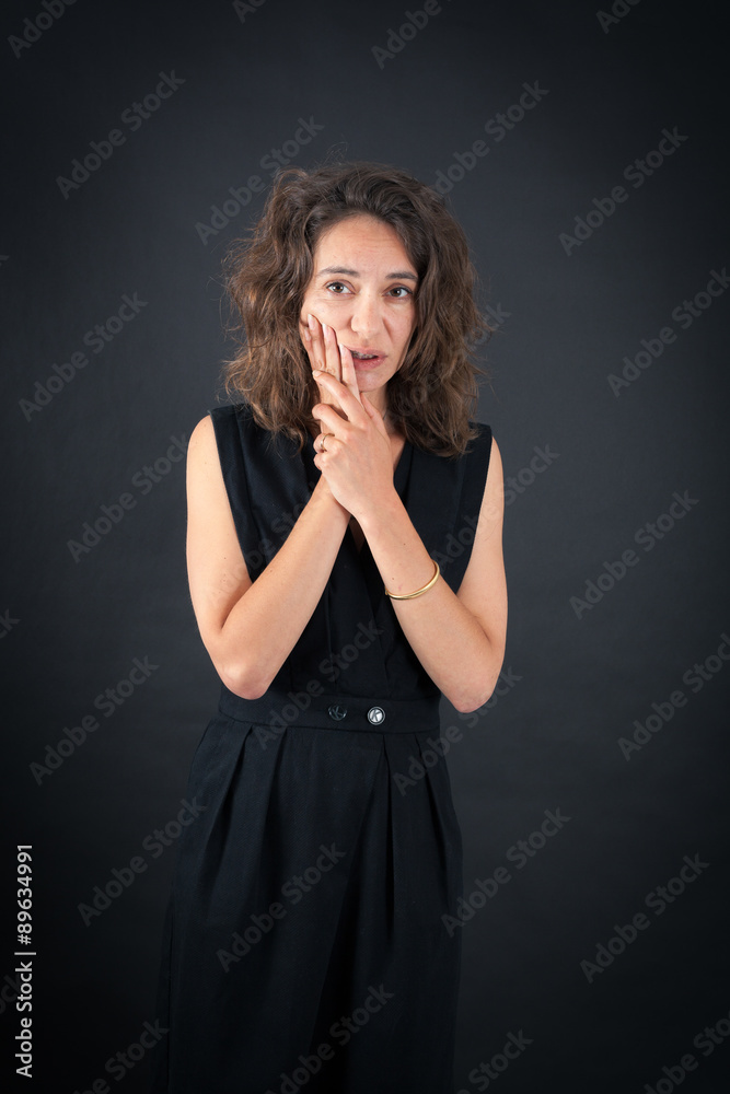 Beautiful woman doing different expressions in different sets of clothes: toothache Beautiful woman doing different expressions in different sets of clothes: toothache