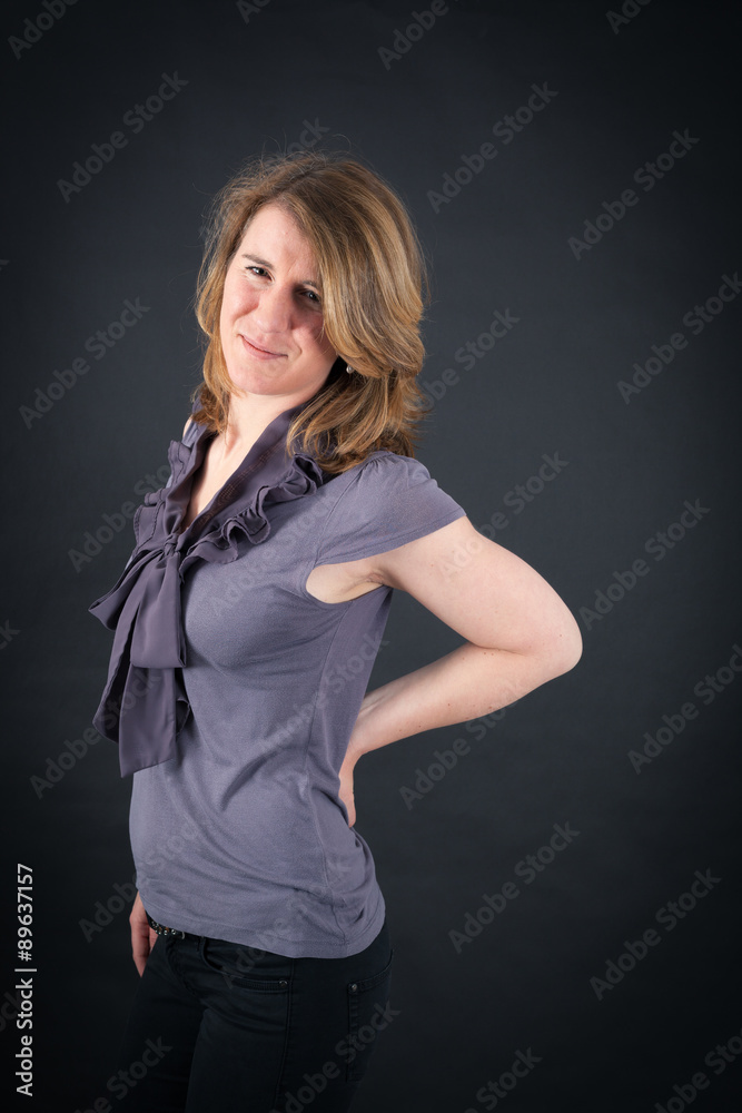 Beautiful woman doing different expressions in different sets of clothes: backache Beautiful woman doing different expressions in different sets of clothes: backache