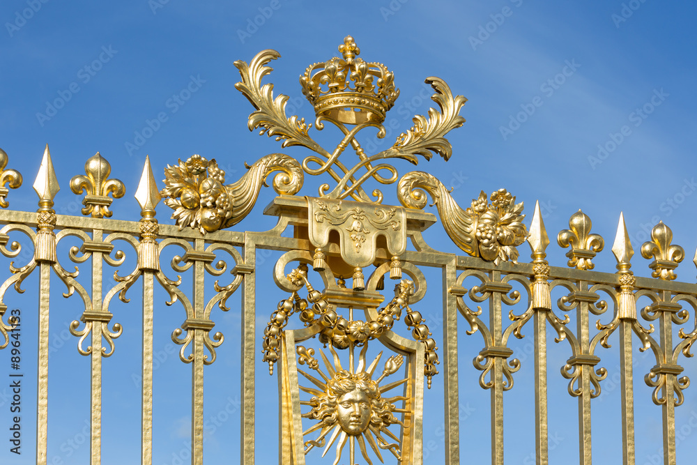 Golden gate with ornament Palace Versailles near Paris, France